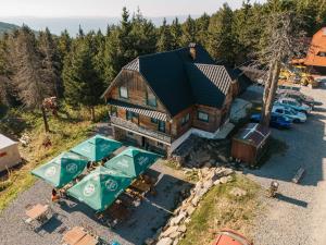 an aerial view of a house with a parking lot at Cabana Vitus Panzió in Harghita-Băi