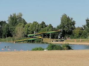 a group of people in the water at a park at ZEcamping 3 étoiles animaux acceptés espace aquatique in Moncontour-de-Poitou +32 photos