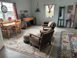 a living room with two chairs and a table at Skull Creek Ranch Cottage in Round Top