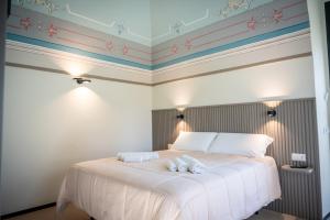 a bedroom with a bed with two towels on it at Casale della Vittoria - Guest House in Taranto