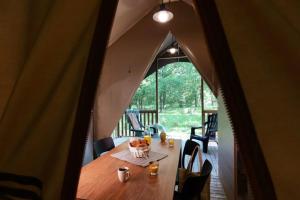 a table in a tent with a bowl of fruit on it at ZEcamping 3 dog friendly salle fitness piscine in Vensac