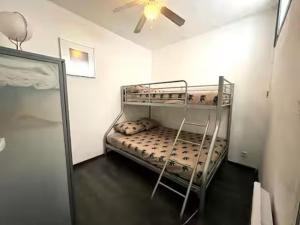a bunk bed in a room with a ceiling fan at Le VILLAJOUN in Saintes-Maries-de-la-Mer