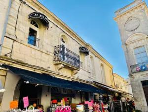 a store front of a building with clothes on display at Le VILLAJOUN in Saintes-Maries-de-la-Mer +8 photos