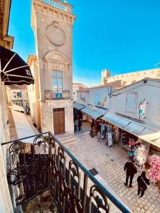 a building with a clock tower on a street at Le VILLAJOUN in Saintes-Maries-de-la-Mer