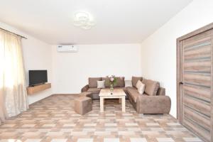 a living room with a couch and a table at Riposo Hotel Armenia in Pʼarakʼar
