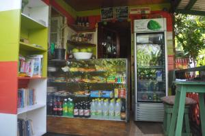a store with a refrigerator with drinks in it at Judy House Cottages and Rooms in Negril