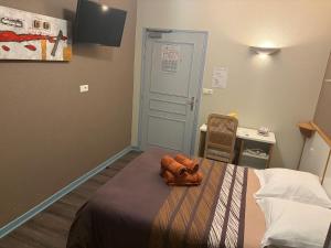 a hospital room with a bed with a towel on it at Hôtel du Centre in Gueugnon