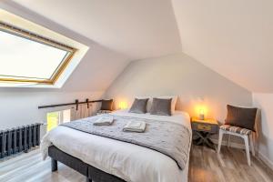 a bedroom with a large bed and a window at Weekend dans la villa Léonie in Kerlouan