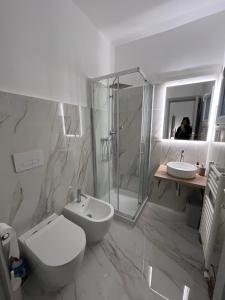a bathroom with a toilet and a shower and a sink at Suite LA BARONESSA in Lecce +42 photos