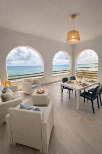 a living room with a view of the ocean at La riva in Noto Marina