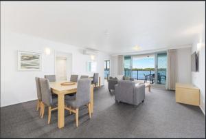 a dining room with a table and chairs at River's Edge Premium Retreat in Ballina