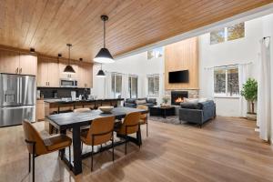 a kitchen and living room with a table and chairs at The Dacha in Island Park
