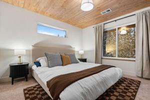 a bedroom with a large bed and a window at The Dacha in Island Park