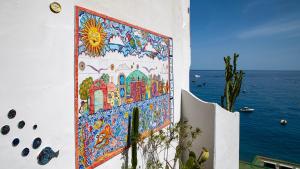 a mural on the side of a building with the ocean at La Dolce Vita a Positano boutique hotel in Positano