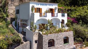 a house on the side of a mountain at La Dolce Vita a Positano boutique hotel in Positano