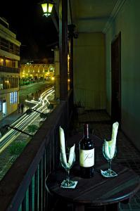 a bottle of wine and two wine glasses on a table at Hoteles Riviera Colonial in Arequipa +25 photos
