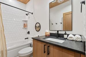 a bathroom with a sink and a tub and a toilet at The Dacha in Island Park +32 photos