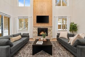 a living room with two couches and a fireplace at The Dacha in Island Park