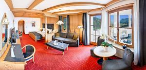 a hotel room with a red carpet at Panorama Vital Hotel Rimmele in Tirolo