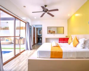 a bedroom with a bed and a ceiling fan at Bali Villas Panglao Bohol in Panglao Island +53 photos