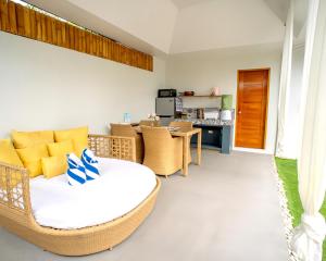 a living room with a wicker couch and a table at Bali Villas Panglao Bohol in Panglao Island