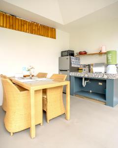 a kitchen with a table and chairs and a stove at Bali Villas Panglao Bohol in Panglao Island