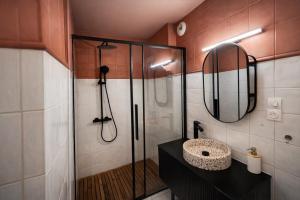 a bathroom with a shower and a sink and a mirror at LE PANCAUT- Chaleureux - Hyper Centre in Mont-de-Marsan