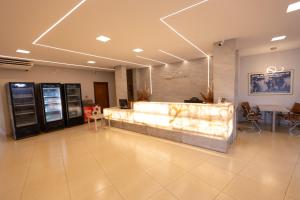 a lobby with a cash counter in a building at Aldeias Palace Hotel in Tucuma