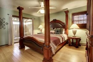 a bedroom with a large canopy bed and a window at Alpine Getaway 62 in Helen