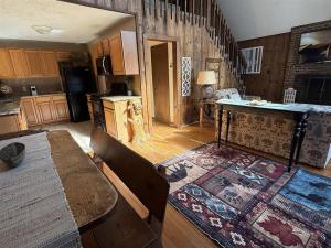 a living room with a table and a kitchen at Alpine Getaway 62 in Helen