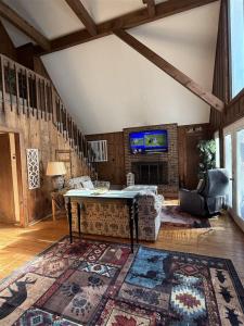a living room with a couch and a table at Alpine Getaway 62 in Helen