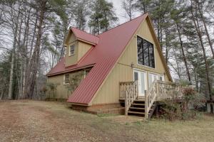 a yellow and red house with a red roof at Alpine Getaway 62 in Helen