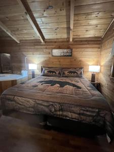 a bedroom with a large bed in a log cabin at Bavarian Hideaway 46 in Sautee Nacoochee