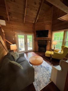 a living room with a couch and a table at Bavarian Hideaway 46 in Sautee Nacoochee