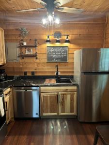 a kitchen with a sink and a refrigerator at Bavarian Hideaway 46 in Sautee Nacoochee +5 photos