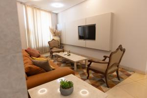 a living room with a couch and a table at Aldeias Palace Hotel in Tucuma