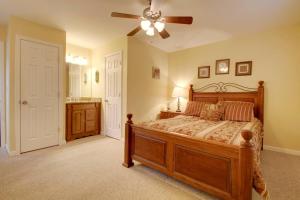 a bedroom with a bed and a ceiling fan at Bavarian Brook Condo 15 in Helen