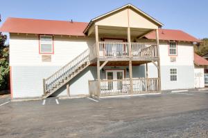 a building with a deck and a staircase on it at Bavarian Brook Condo 15 in Helen