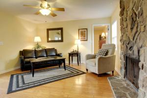 a living room with a couch and a fireplace at Bavarian Brook Condo 15 in Helen