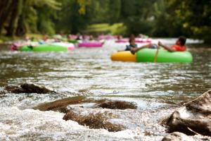 a group of people are rafting down a river at Bavarian Brook Unit 6 in Helen