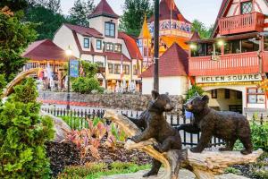 two bear statues sitting on a log in front of a town at Bavarian Brook Unit 9 in Helen