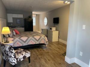 a bedroom with a bed and a chair in it at Bavarian Brook Unit 8 in Helen
