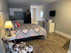 a bedroom with a bed and a chair and a lamp at Bavarian Brook Unit 8 in Helen