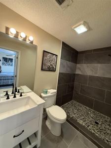 a bathroom with a white toilet and a sink at Rivers Edge 703A in Helen