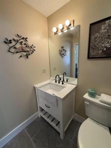 a bathroom with a sink and a toilet and a mirror at Rivers Edge 703A in Helen