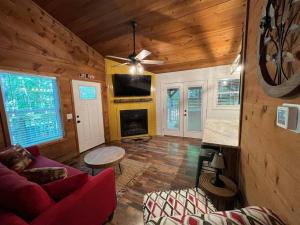 a living room with a red couch and a fireplace at Bavarian Hideaway 25 in Helen