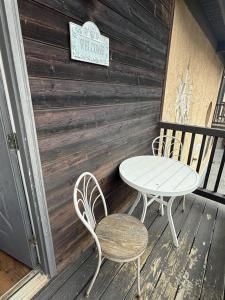 two chairs and a table on a porch at Rivers Edge 803A in Helen