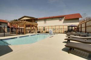 a swimming pool with lounge chairs in front of a building at Bavarian Brook Unit 7 in Helen