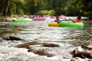a group of people are rafting down a river at Bavarian Brook Unit 7 in Helen