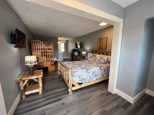 a bedroom with a bed and a table with a lamp at Bavarian Brook Unit 4a in Helen